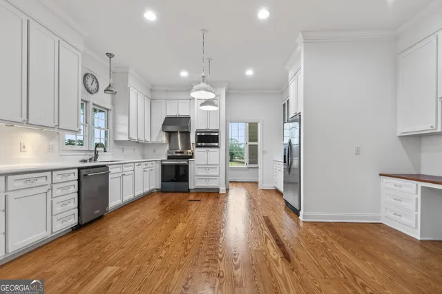 a kitchen with wooden floors and wooden cabinets