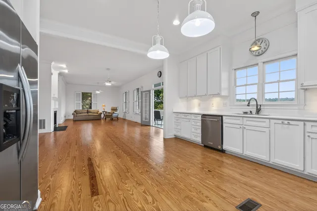 a large kitchen with granite countertop a large counter top stainless steel appliances and cabinets