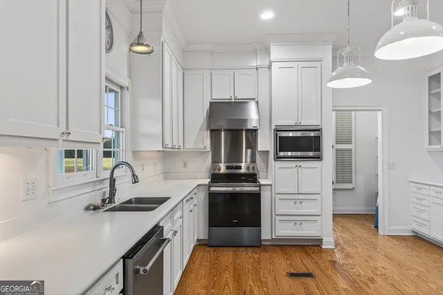 a bathroom with a sink toilet and a mirror