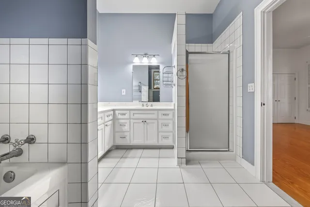 a bathroom with a double vanity sink mirror and toilet