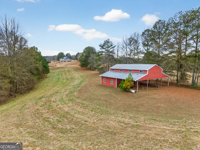 an aerial view of a house with a yard and lake view