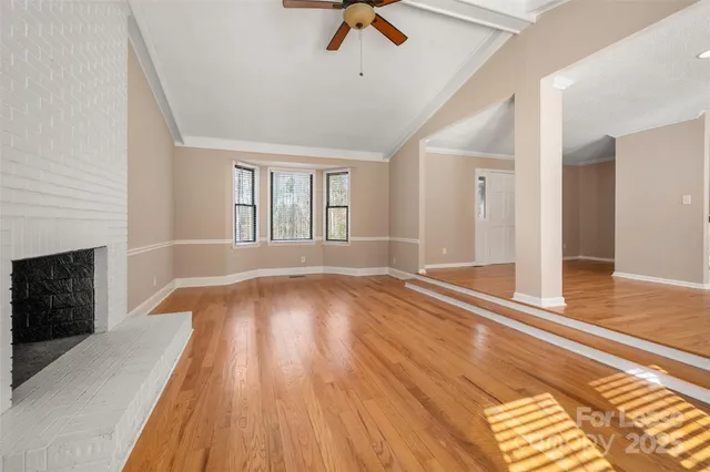 wooden floor in an empty room with a fireplace