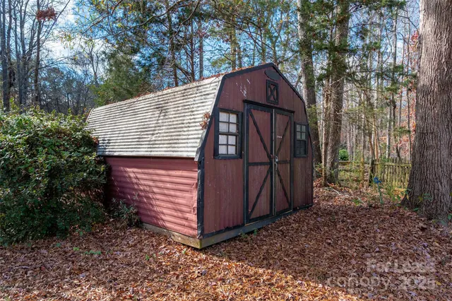 a view of a small house in the forest