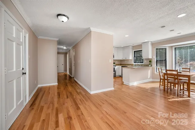 a view of a kitchen with dining space wooden floor and a window