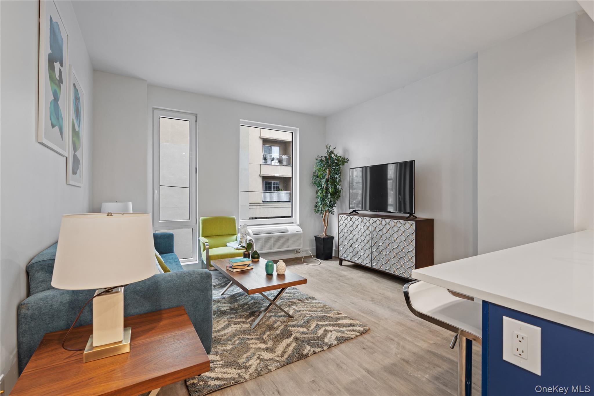 40 Westchester Place, Unit 510 New Rochelle, NY 10801 - Photo 5 of 10 a living room with furniture and a flat screen tv