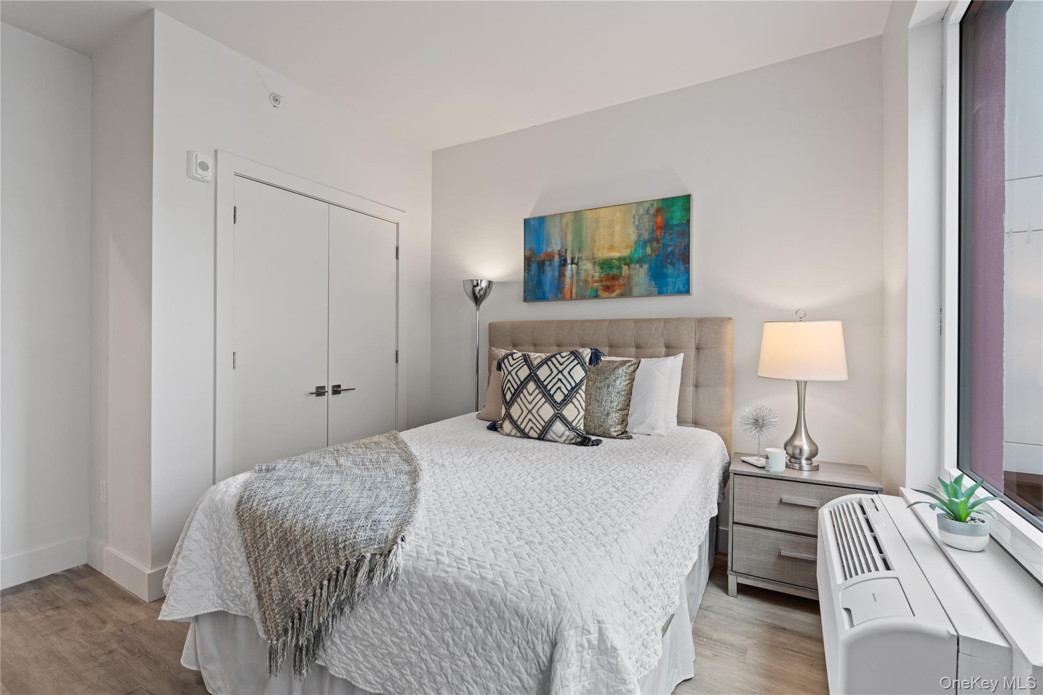 40 Westchester Place, Unit 510 New Rochelle, NY 10801 - Photo 10 of 10 a bedroom with a bed and a lamp