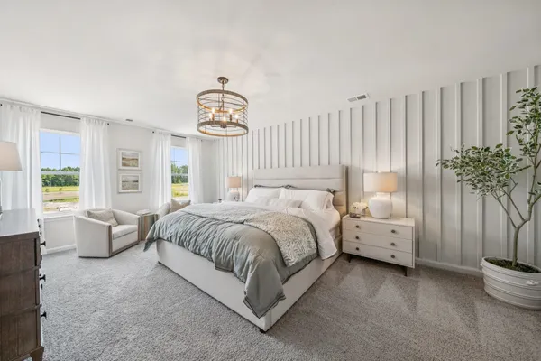 a spacious bedroom with a bed and a large window