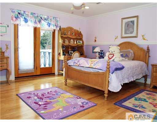 421 Plainfield Road Edison, NJ 08820 - Photo 14 of 21 a bedroom with a bed and wooden floor