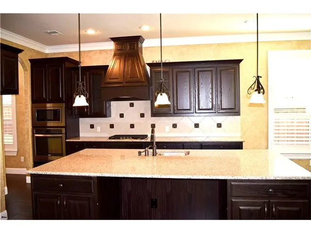 a kitchen with a sink a cabinets and window