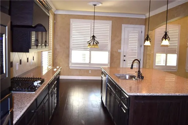 a kitchen with a sink stove and cabinets