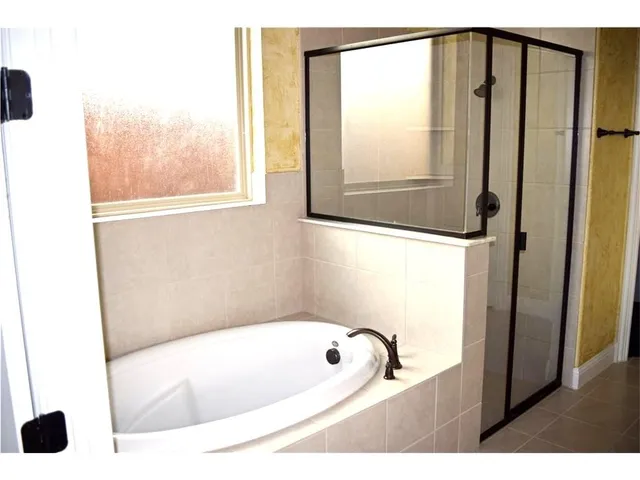 a bathroom with a bathtub and a shower