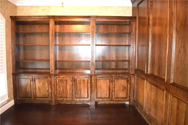 a view of a room with wooden floor and windows