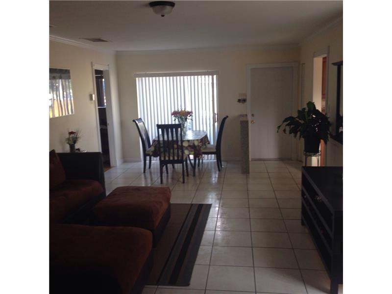 9171 Southwest 5th Street, Unit A Boca Raton, FL 33428 - Photo 3 of 8 a dining room with furniture and a window