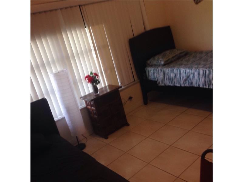 9171 Southwest 5th Street, Unit A Boca Raton, FL 33428 - Photo 4 of 8 a living room with furniture