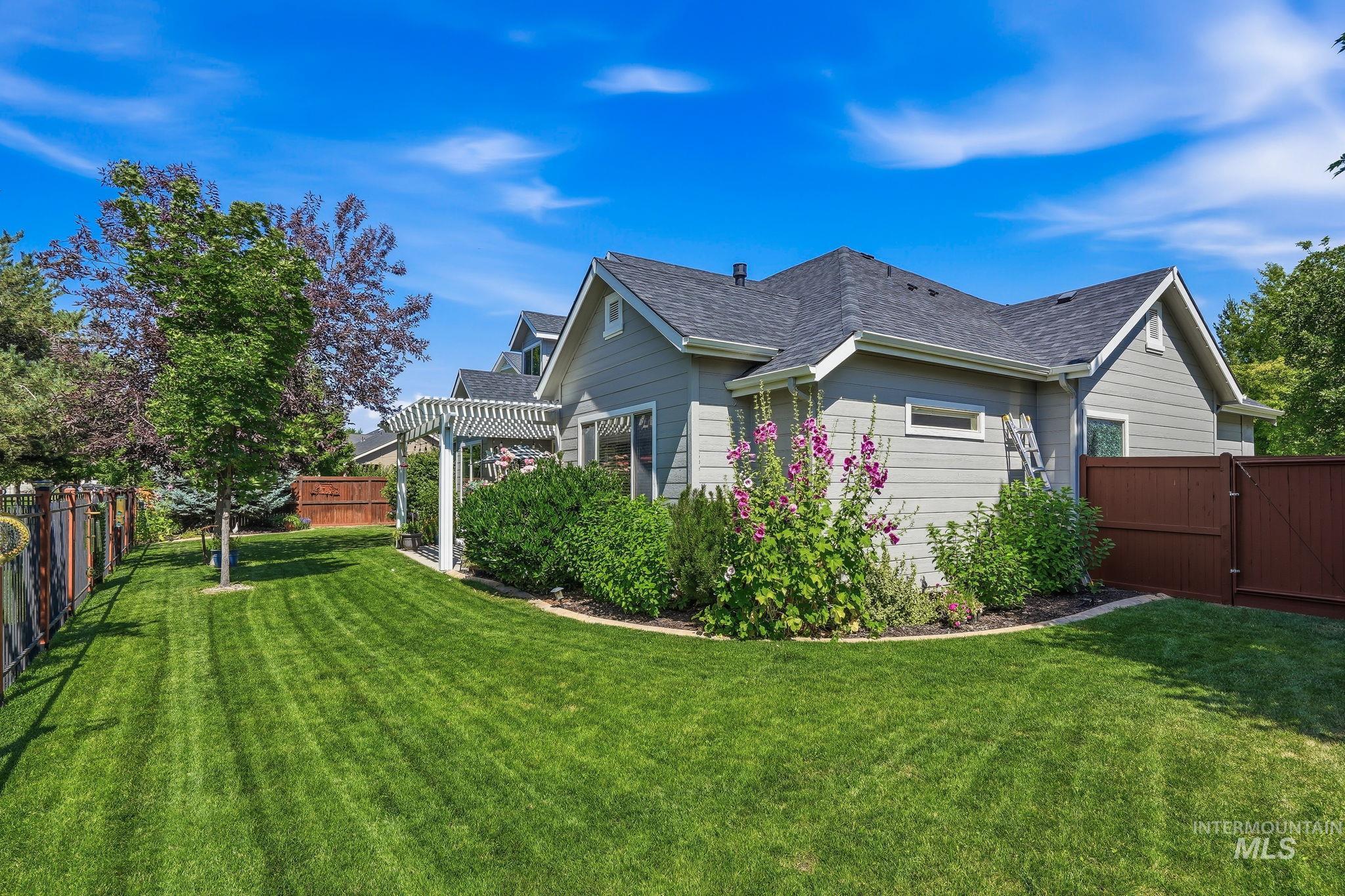 3969 North Hollymount Way Meridian, ID 83646 - Photo 43 of 47 Expansive green lawn with established landscaping and a white pergola