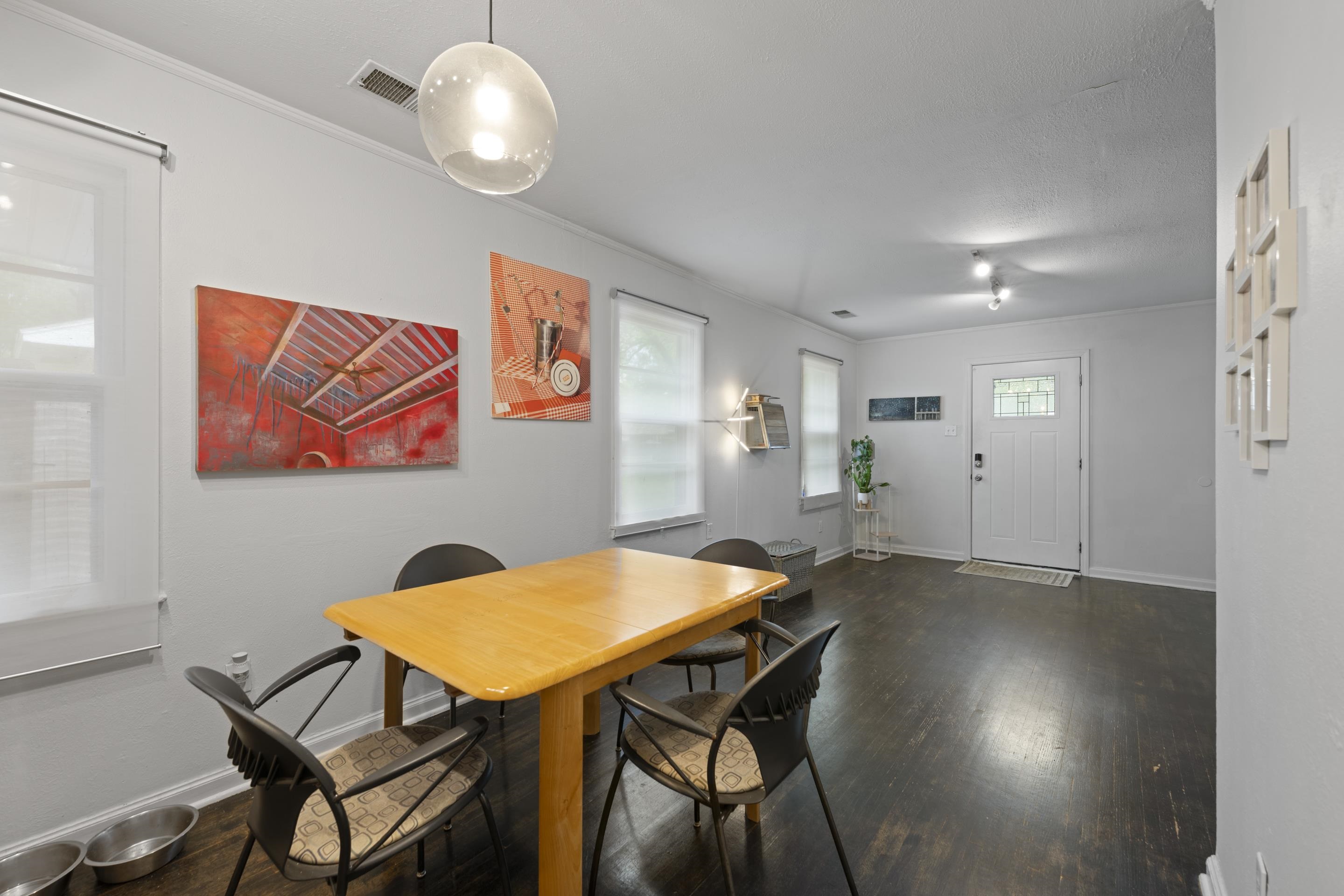 1343 Dearing Road Memphis, TN 38117 - Photo 6 of 19 Open-concept living area with dark wood-finish flooring, light grey walls, and multiple windows with roller shades