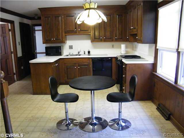 2710 Old Gun Road West Midlothian, VA 23113 - Photo 5 of 12 a kitchen with stainless steel appliances granite countertop a refrigerator a stove a sink dishwasher and white cabinets with wooden floor
