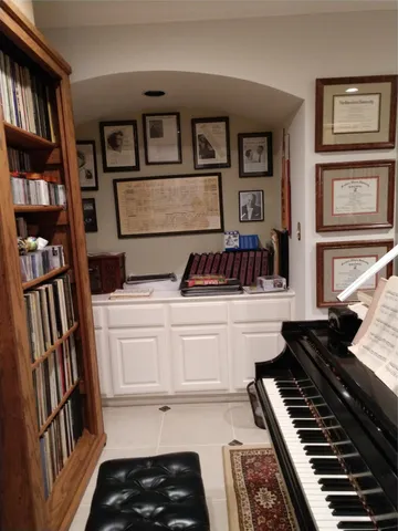 a kitchen with a stove and a bookshelf
