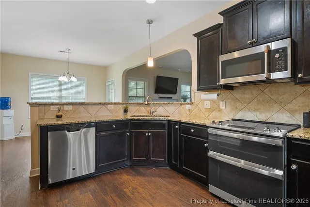 a kitchen with a refrigerator stove and sink