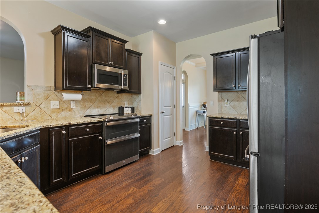 945 Pecan Grove Loop Hope Mills, NC 28348 - Photo 14 of 42 a kitchen with a refrigerator stove and sink