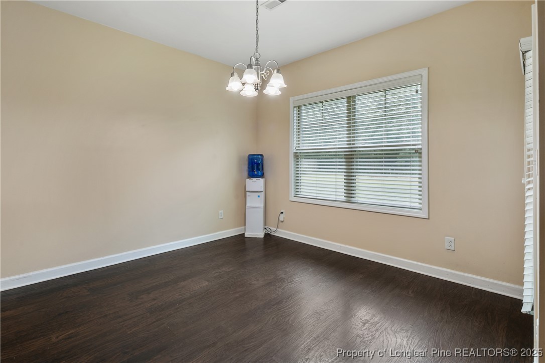 945 Pecan Grove Loop Hope Mills, NC 28348 - Photo 15 of 42 a view of an empty room with wooden floor and a window