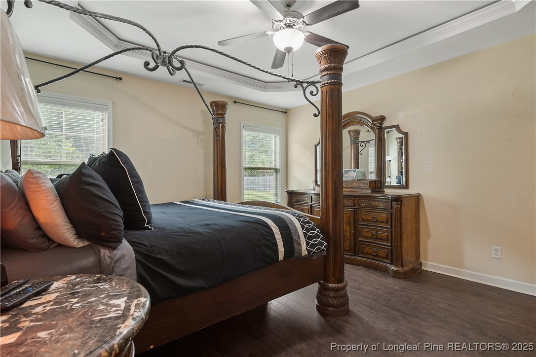 945 Pecan Grove Loop Hope Mills, NC 28348 - Photo 21 of 42 a bed sitting in a bedroom next to a window