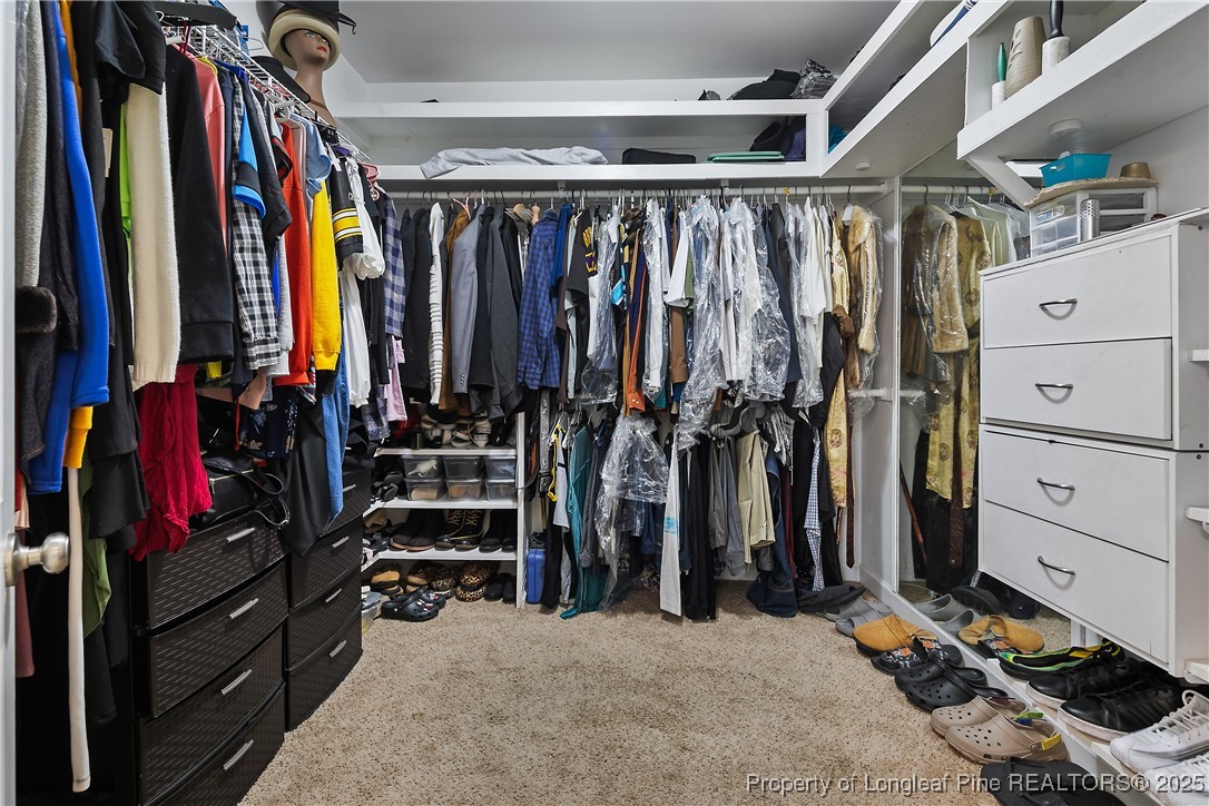 945 Pecan Grove Loop Hope Mills, NC 28348 - Photo 22 of 42 a view of walk in closet with clothes and shoes