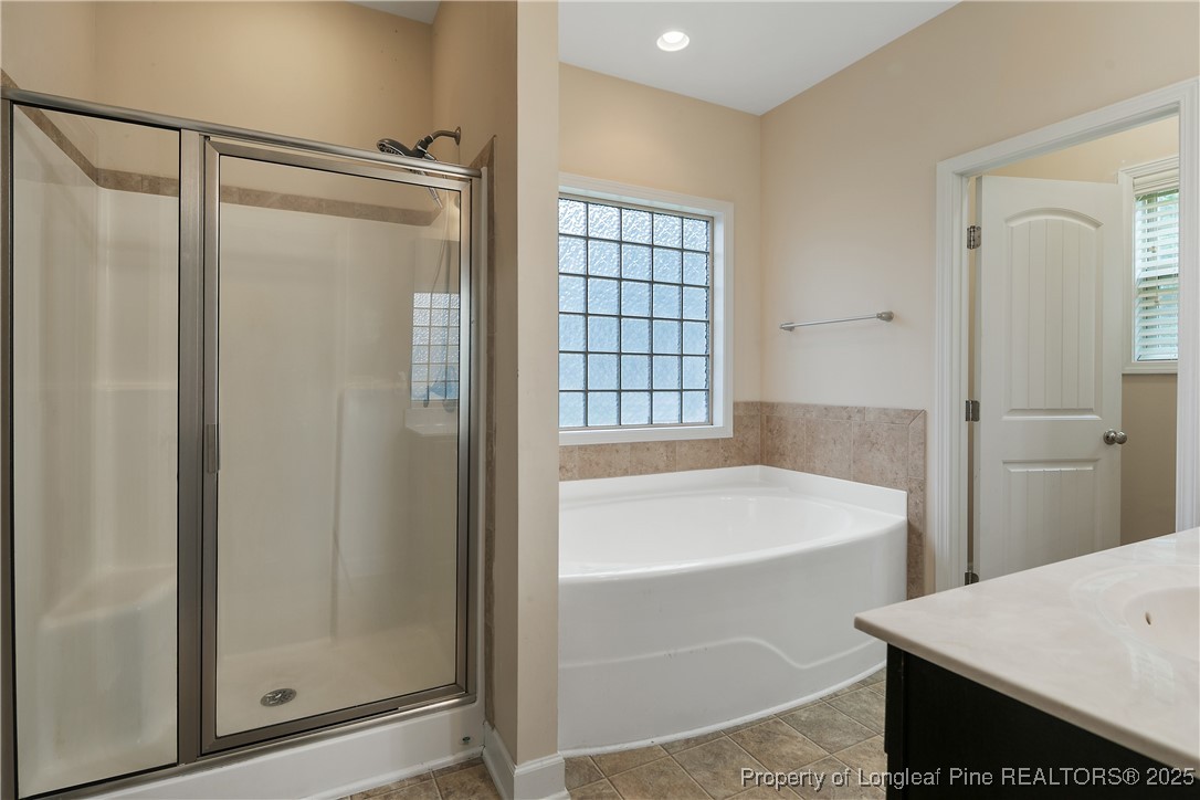 945 Pecan Grove Loop Hope Mills, NC 28348 - Photo 23 of 42 a bathroom with a tub and shower