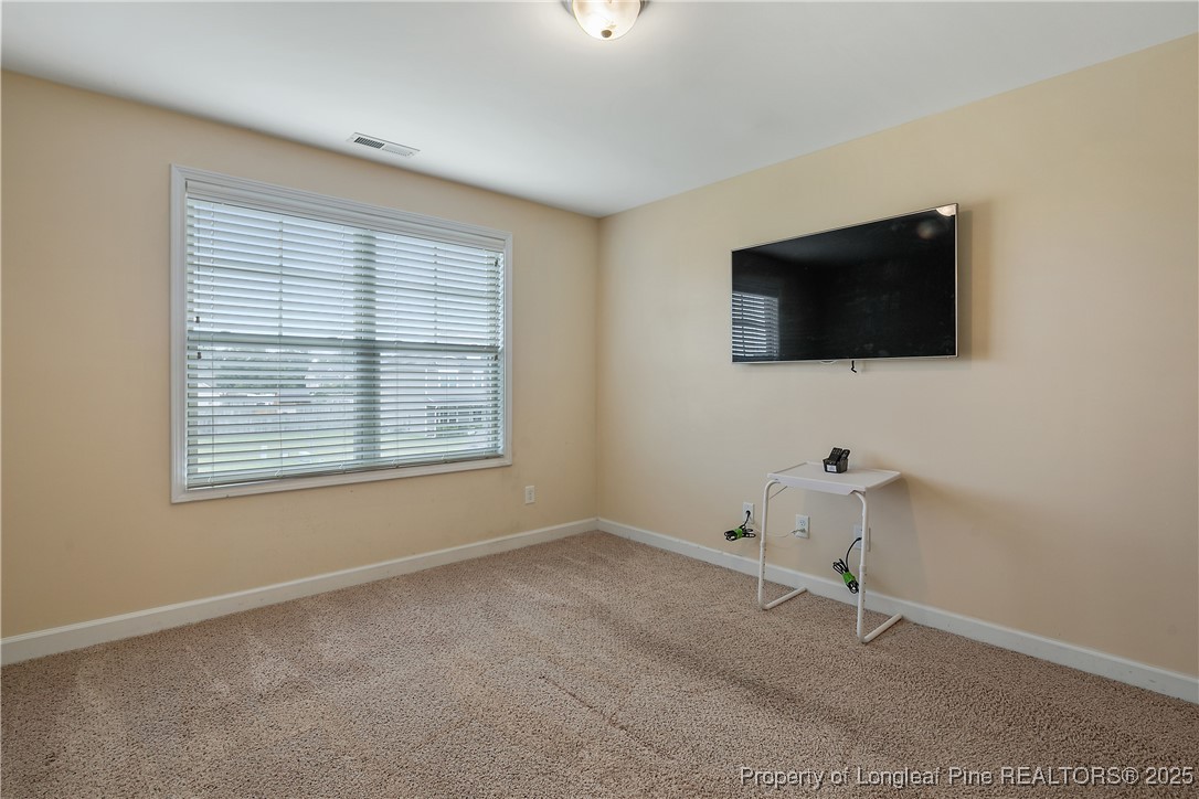 945 Pecan Grove Loop Hope Mills, NC 28348 - Photo 28 of 42 a living room with furniture and a flat screen tv