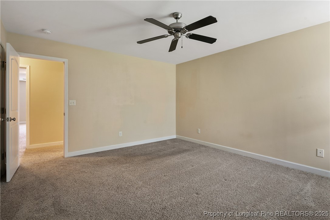 945 Pecan Grove Loop Hope Mills, NC 28348 - Photo 34 of 42 an empty room with a ceiling fan and a window