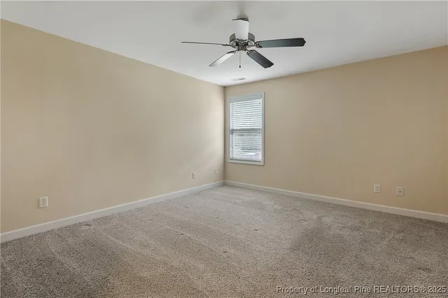 a bathroom with a granite countertop sink toilet and a mirror