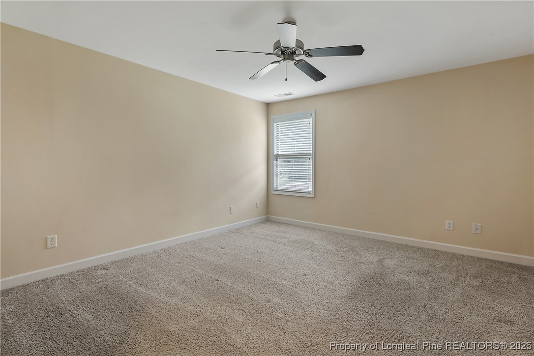 945 Pecan Grove Loop Hope Mills, NC 28348 - Photo 35 of 42 an empty room with windows and fan