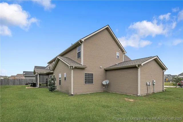 a front view of a house with a garden and trees