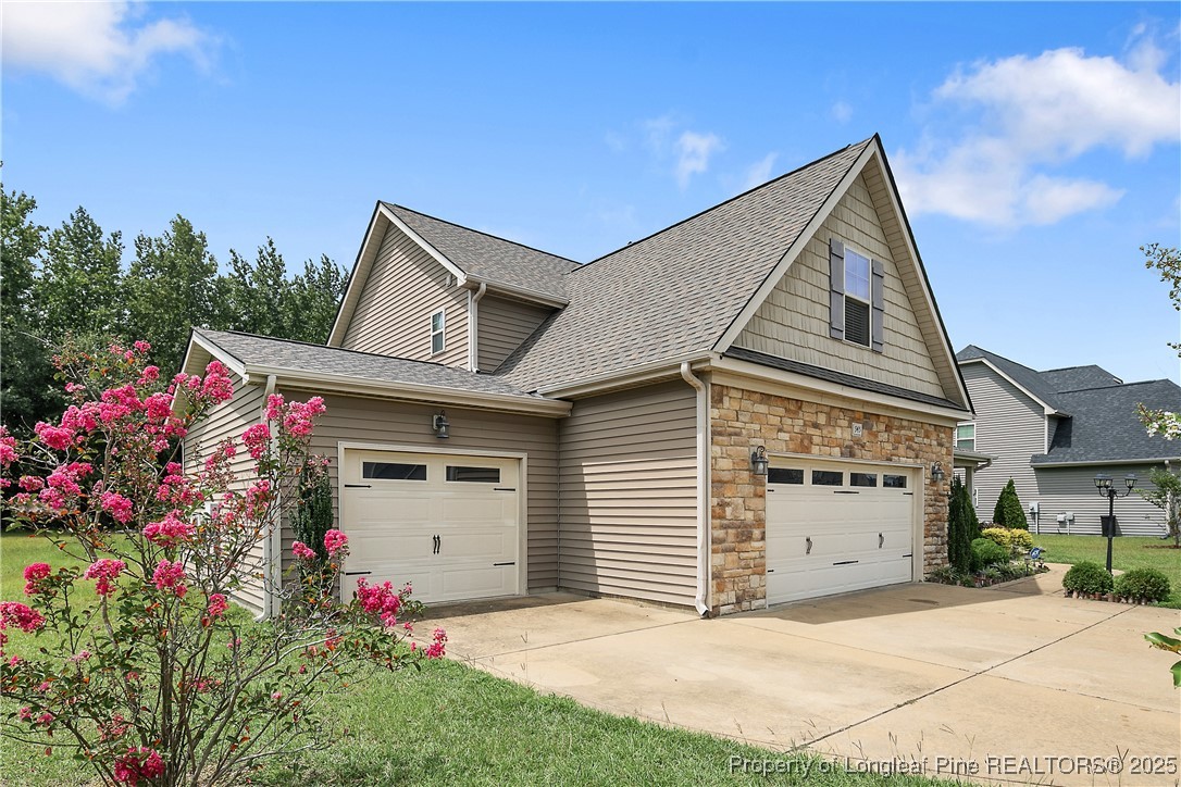 945 Pecan Grove Loop Hope Mills, NC 28348 - Photo 4 of 42 a front view of a house with a garage