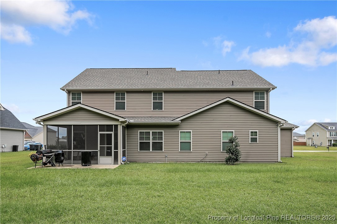 945 Pecan Grove Loop Hope Mills, NC 28348 - Photo 41 of 42 a front view of a house with a garden and trees