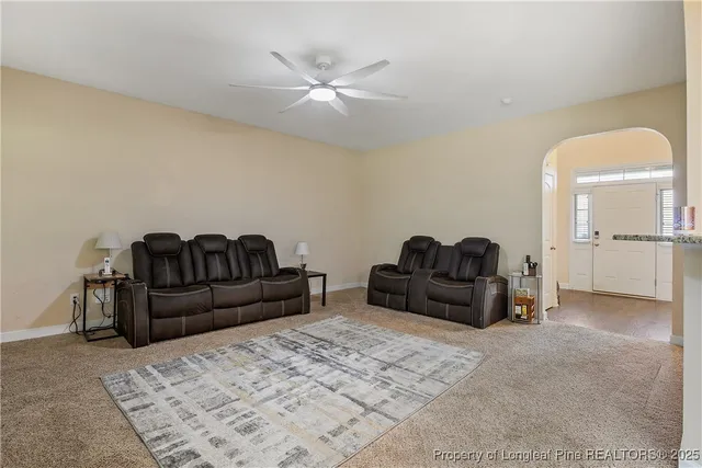 a living room with furniture and a kitchen