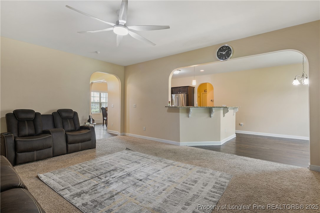 945 Pecan Grove Loop Hope Mills, NC 28348 - Photo 9 of 42 a living room with furniture and a kitchen