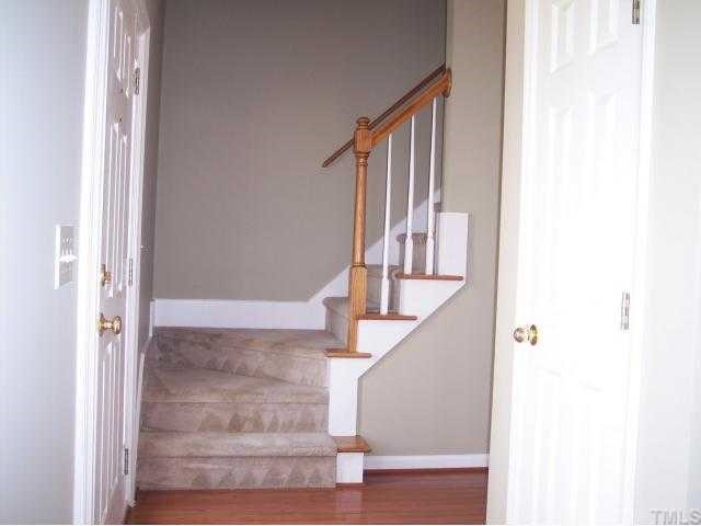 8405 Neuse Timbers Court Raleigh, NC 27616 - Photo 2 of 12 View of the Entry Foyer and Decorative Architectural Staircase. The Upgraded Staircase Entry includes Stained Oak Handrails, Posts and Stair Tread Accents. Solid Oak Hardwood is Found in the Foyer, Entry Hallway and Hallway to the Garage.