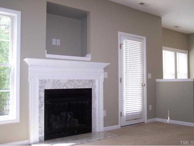 8405 Neuse Timbers Court Raleigh, NC 27616 - Photo 3 of 12 View of the Bright Family Room. The Room is Accented by a Decorative Paddle Fan and a Gorgeous Gas Log Fireplace with Marble Surround & Hearth and an Oversize Decorative Mantle. A Built-In and Pre-Wired TV Niche is Located Above the Fireplace.