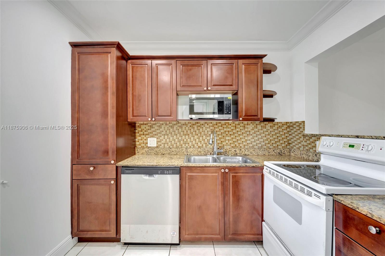 126 South Cypress Road, Unit 729 Pompano Beach, FL 33060 - Photo 4 of 21 a kitchen with stainless steel appliances granite countertop a stove and a microwave