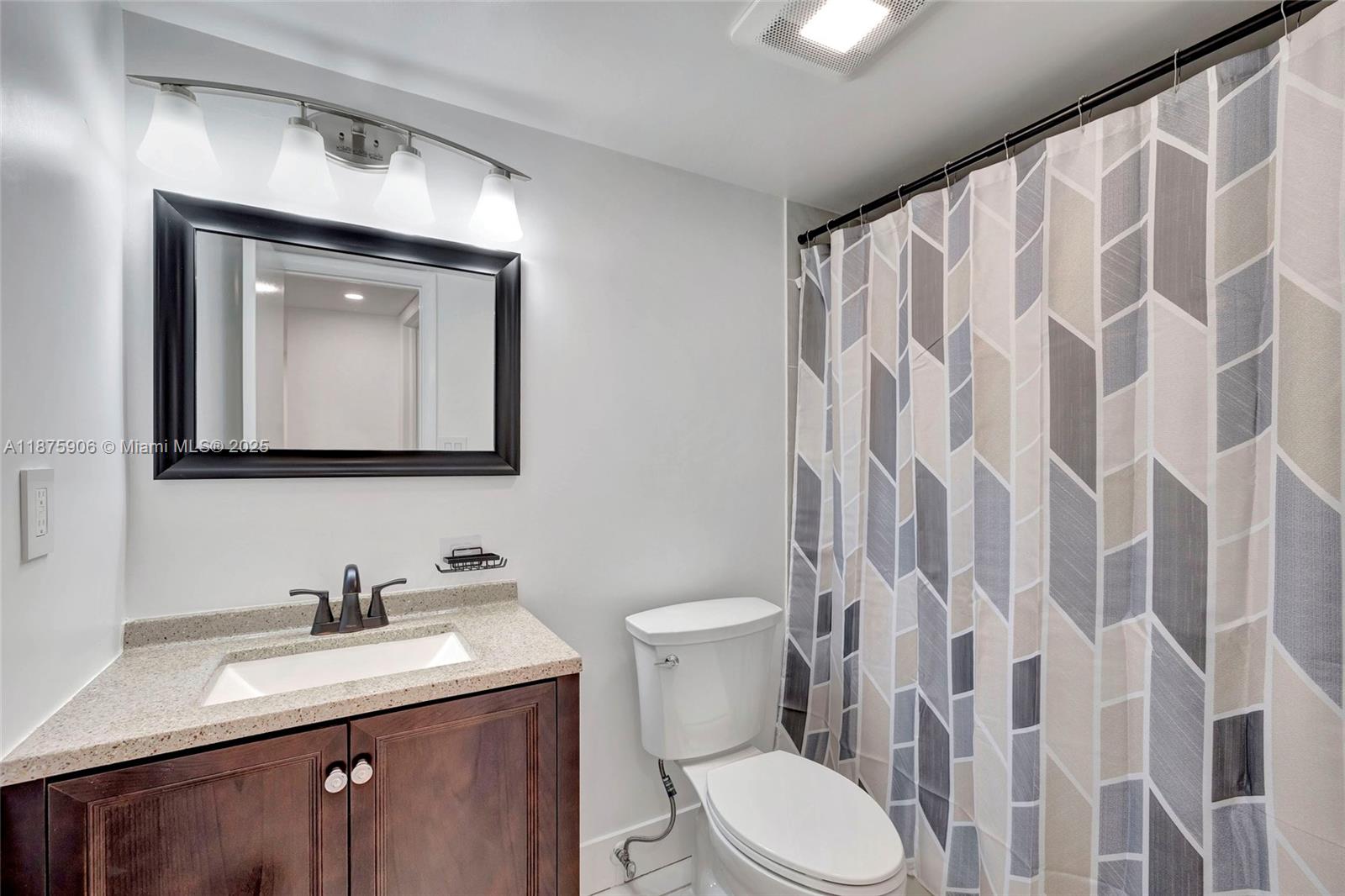 126 South Cypress Road, Unit 729 Pompano Beach, FL 33060 - Photo 9 of 21 a bathroom with a granite countertop sink a toilet and a mirror