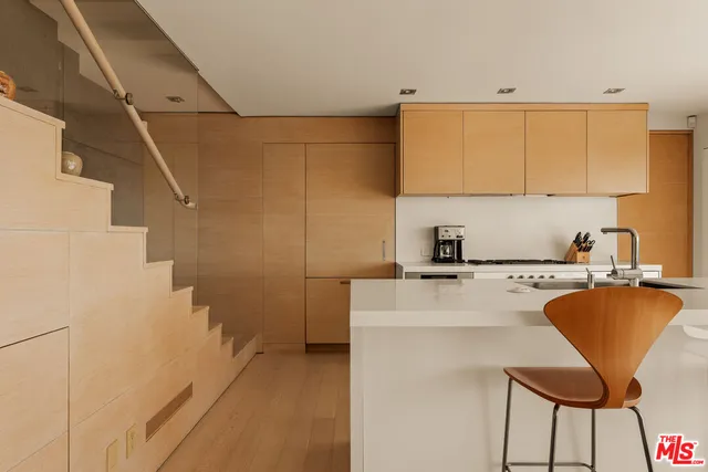 a kitchen with a sink cabinets and window
