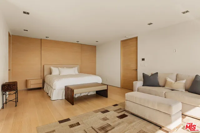 a bedroom with a bed and a couch