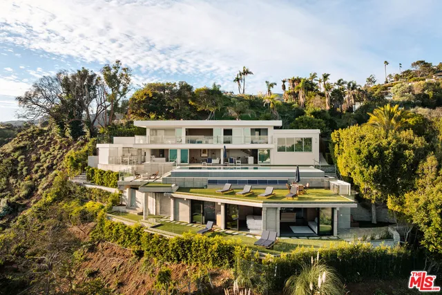 a view of a building with a lot of plants and trees