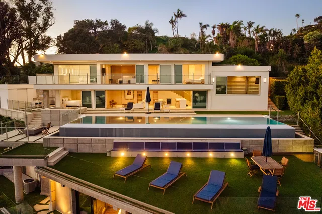 a view of a swimming pool with chairs
