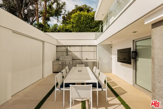 a view of a patio with table and chairs