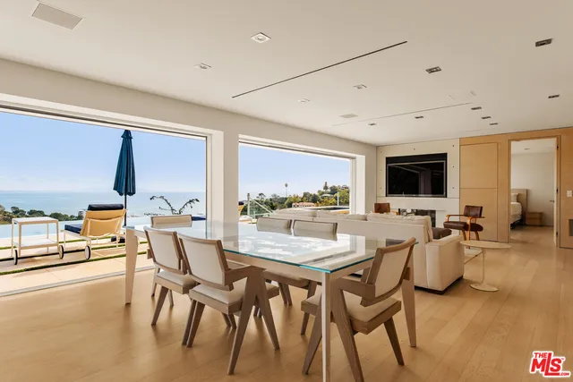 a dining room with furniture and wooden floor