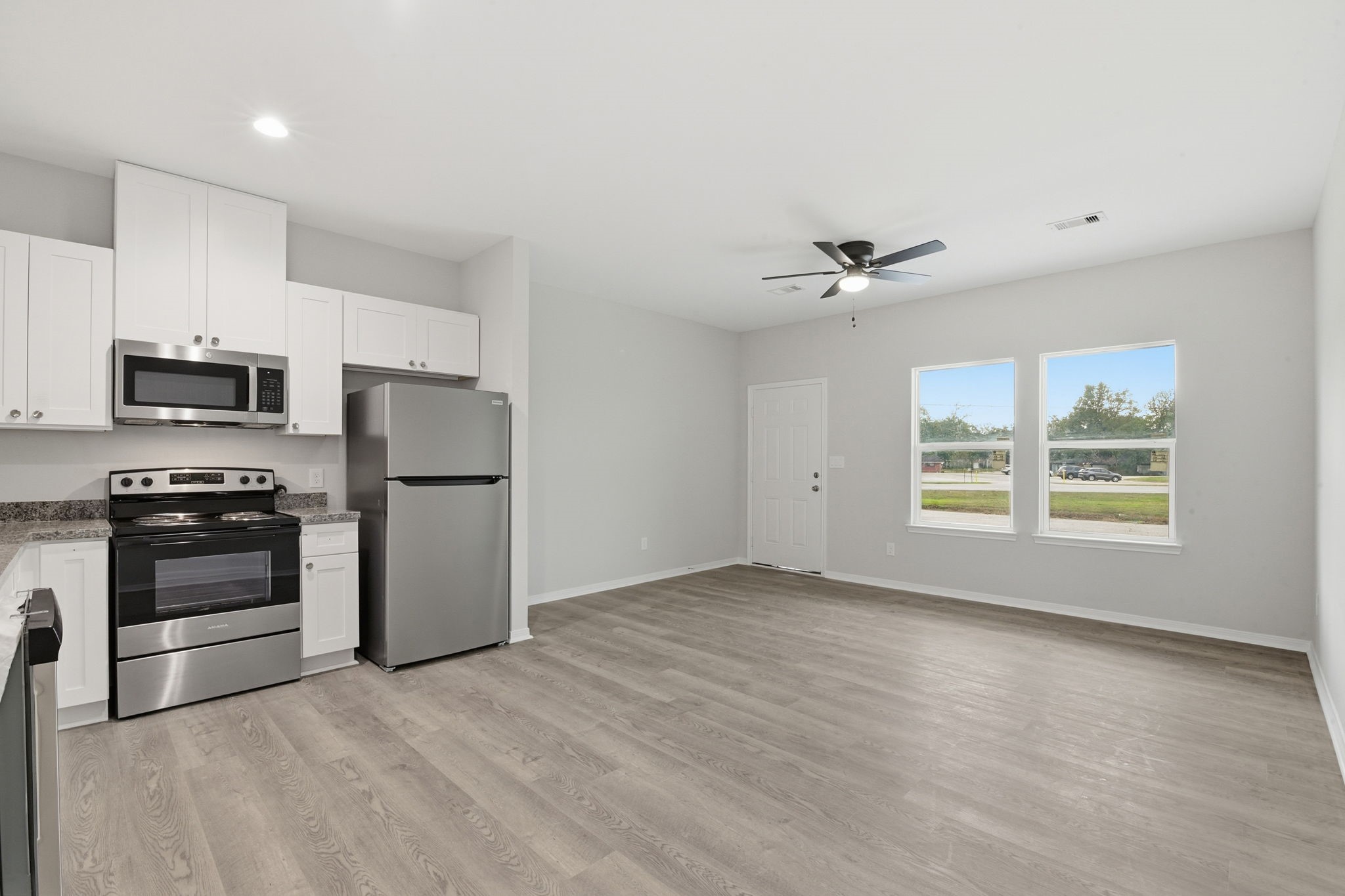 2521 Maple Street, Unit 2521A Liberty, TX 77575 - Photo 11 of 25 a view of kitchen with sink microwave and refrigerator
