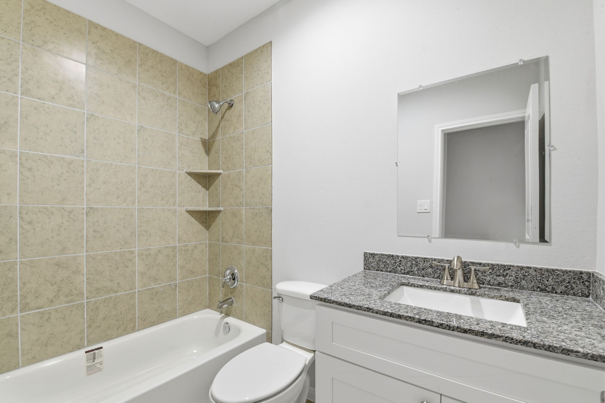 2521 Maple Street, Unit 2521A Liberty, TX 77575 - Photo 15 of 25 a bathroom with a granite countertop sink toilet and shower