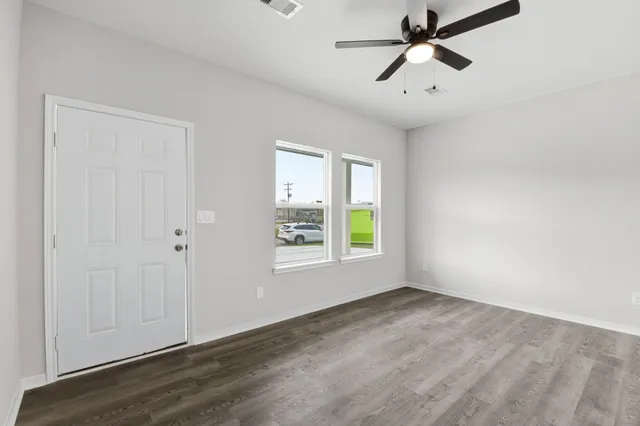 wooden floor in an empty room with a window
